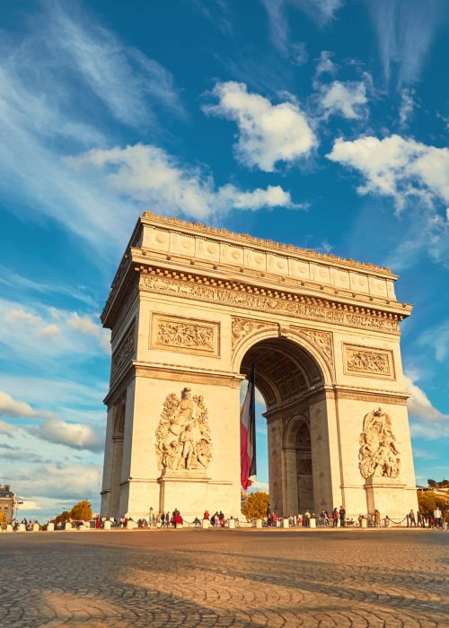Arc de Triumph in Paris with beautiful clouds behind on a bright afternoon in Autumn. Panoramic filtered mage.