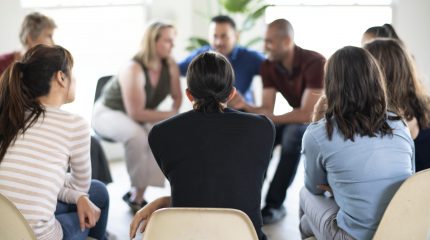 Diverse people in a supporting group session